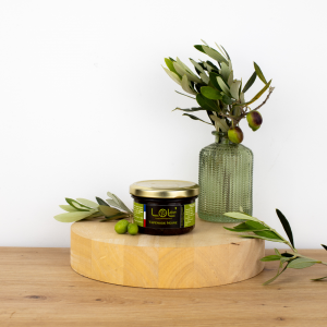 Pot de tapenade noire de Maison Leydier, sur fond naturel avec olives fraîches et branches d'olivier. Produit artisanal de qualité, fabriqué en France.