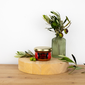 Pot de pâté d'olive verte de Maison Leydier, sur fond naturel avec olives fraîches et branches d'olivier. Produit artisanal de qualité, fabriqué en France.